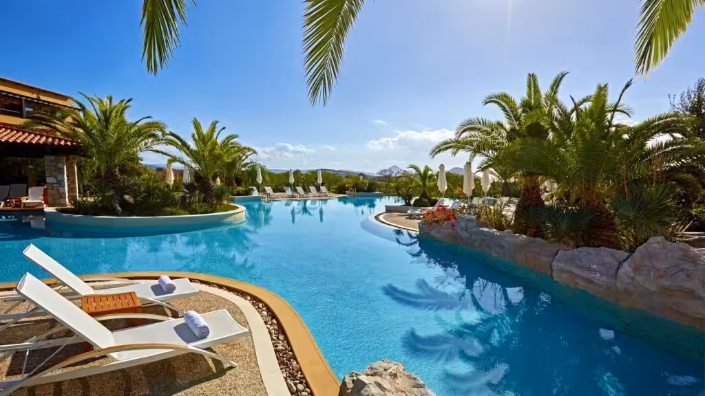 Resort pool with palm trees near Costa Navarino